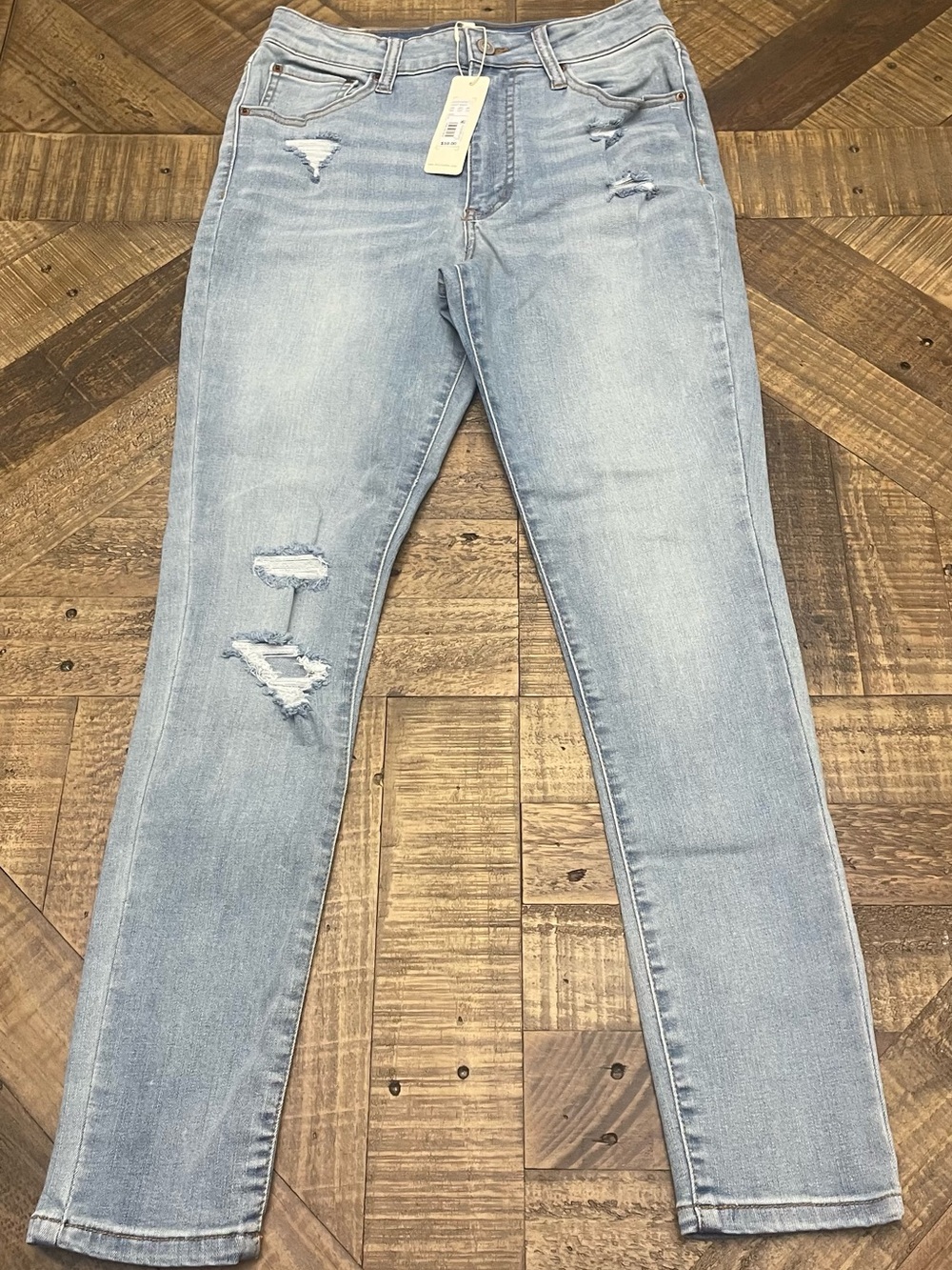 light wash, high-rise distressed denim from the brand Copper Key